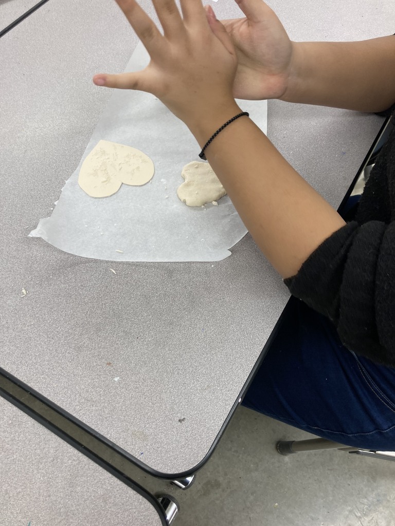Student shapes cookie dough into heart