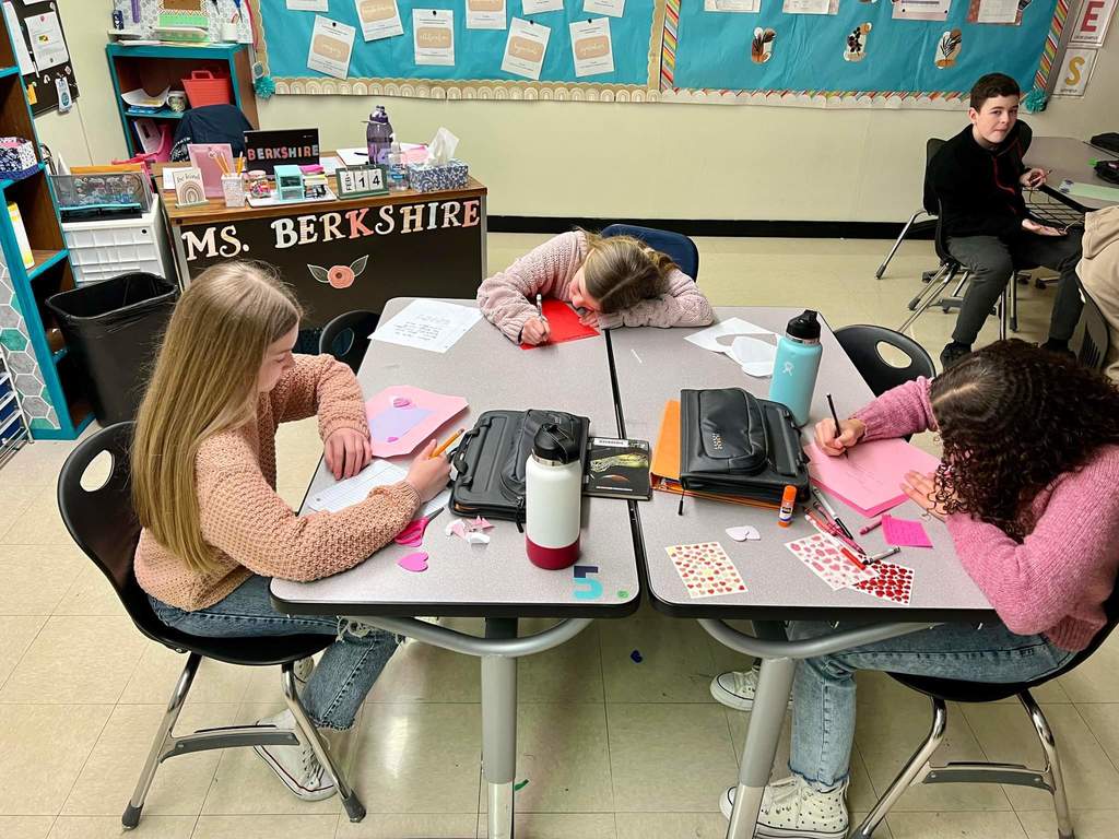 Group of students at tables working on their Valentine's Day projects