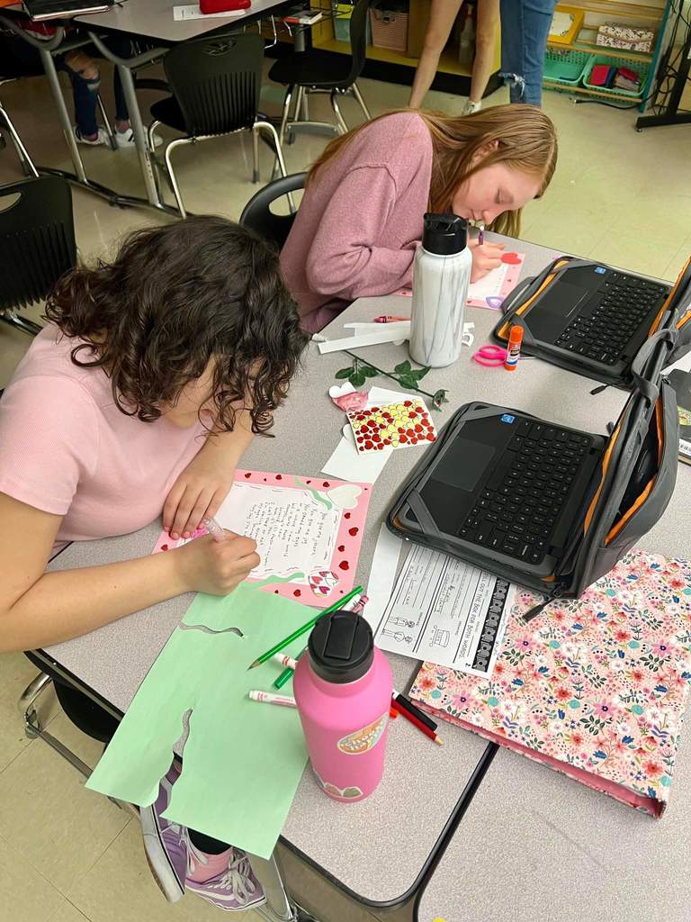 2 students working on their Valentine's Day Poem